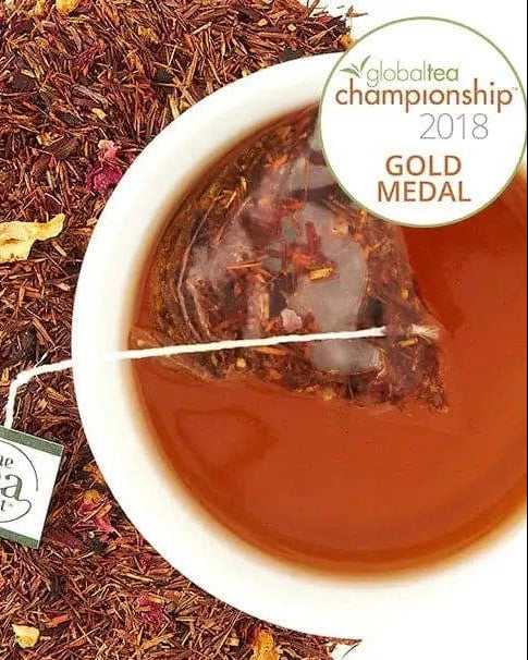 Tea leaves, tea bag, and brewed tea with 'The Tea Spot' label and 'Global Tea Championship 2018 Gold Medal' badge.