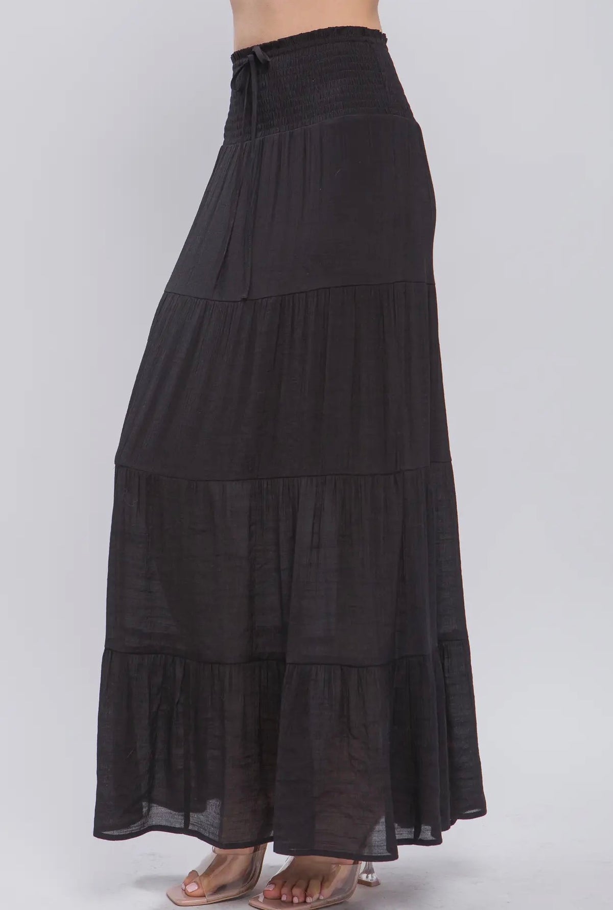 Black tiered maxi skirt on a white background