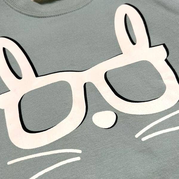 Gray sweatshirt with a large white graphic of sunglasses on a gray background