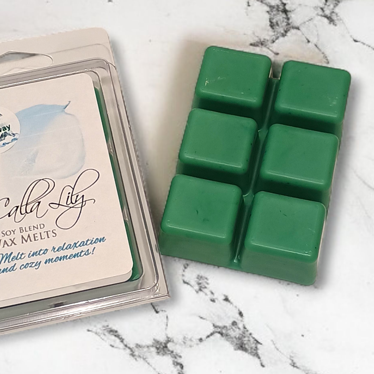Green wax melts in a packaging on a marble surface