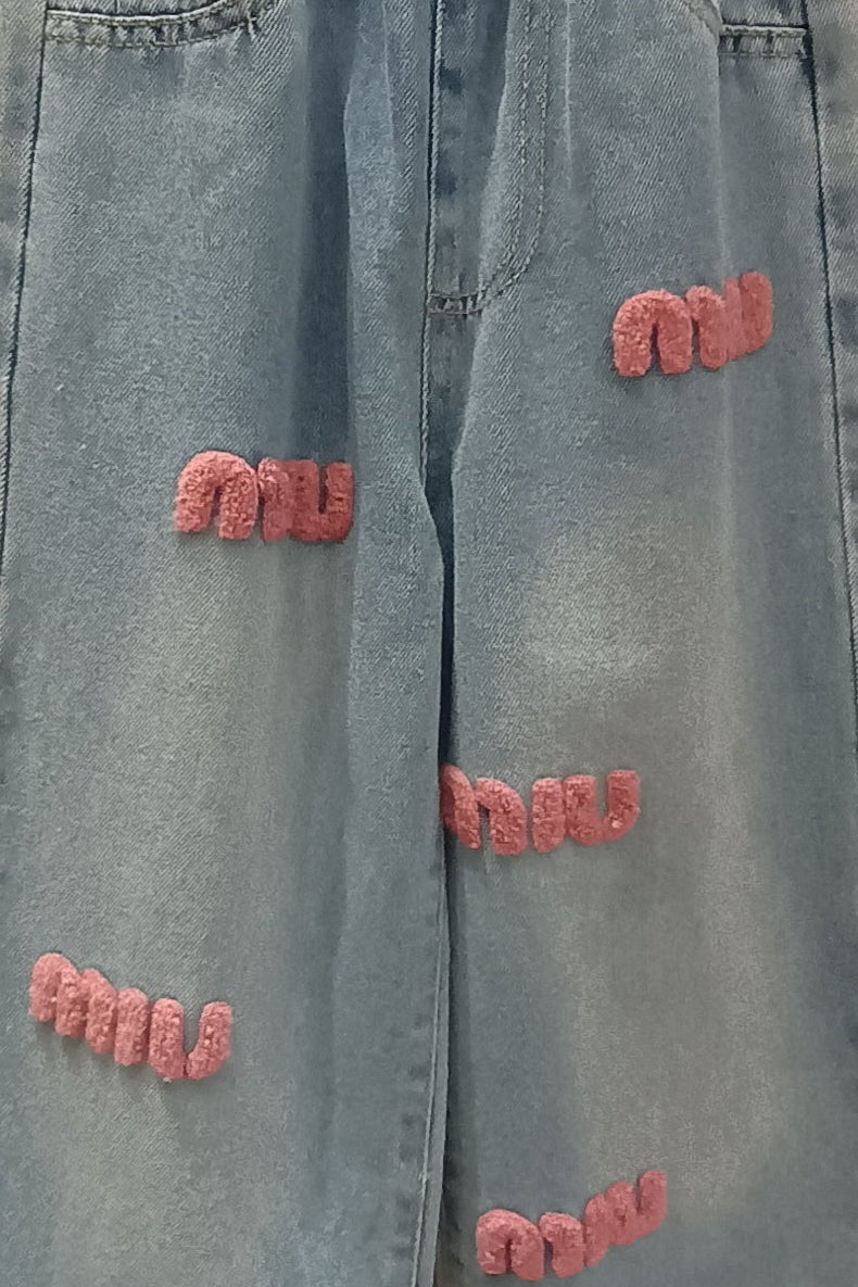 Light blue jeans with distressed details on a hanger against a store background
