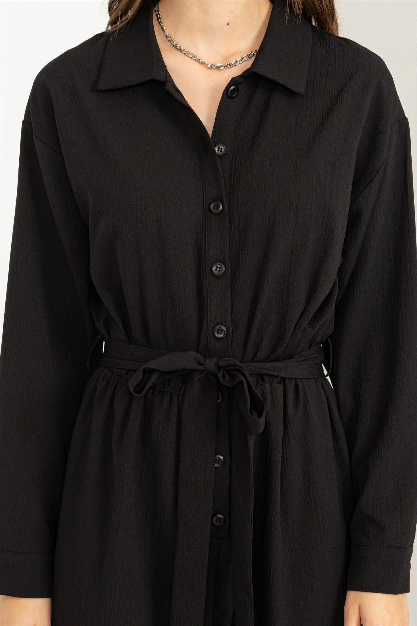 Black dress with a belt on a white background