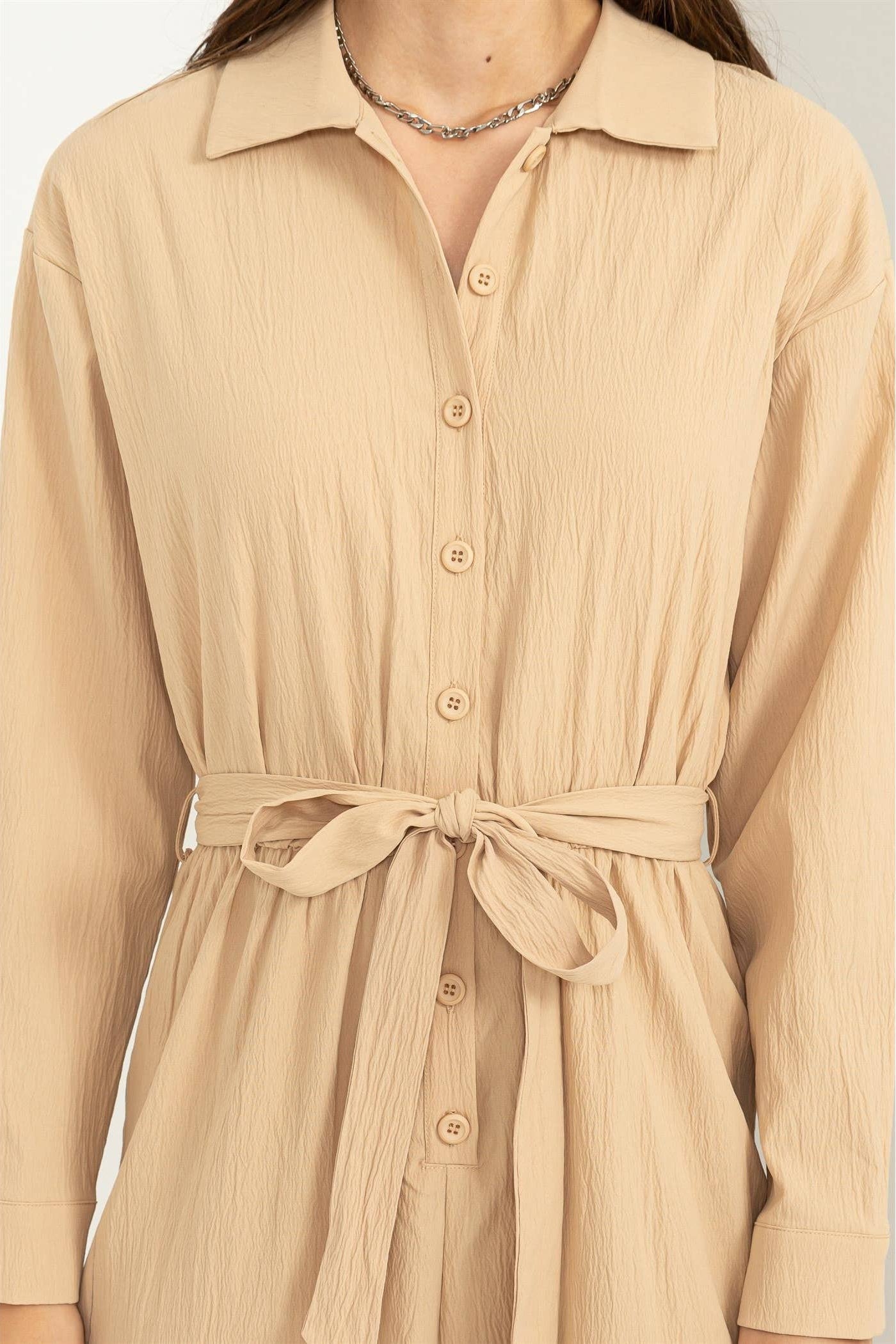 Beige dress with a belt on a white background