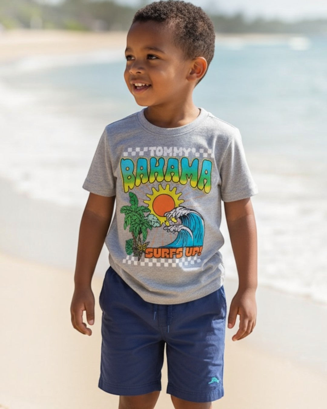 Child wearing a Tommy Bahama shirt on a beach