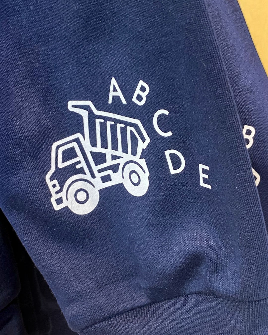 Navy blue fabric with white logo and text