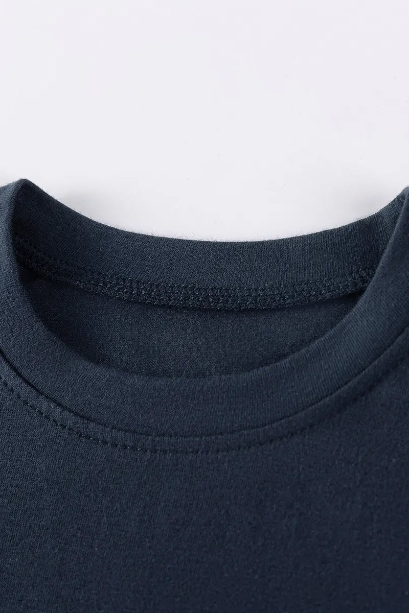 Close-up of a navy blue garment with a white background