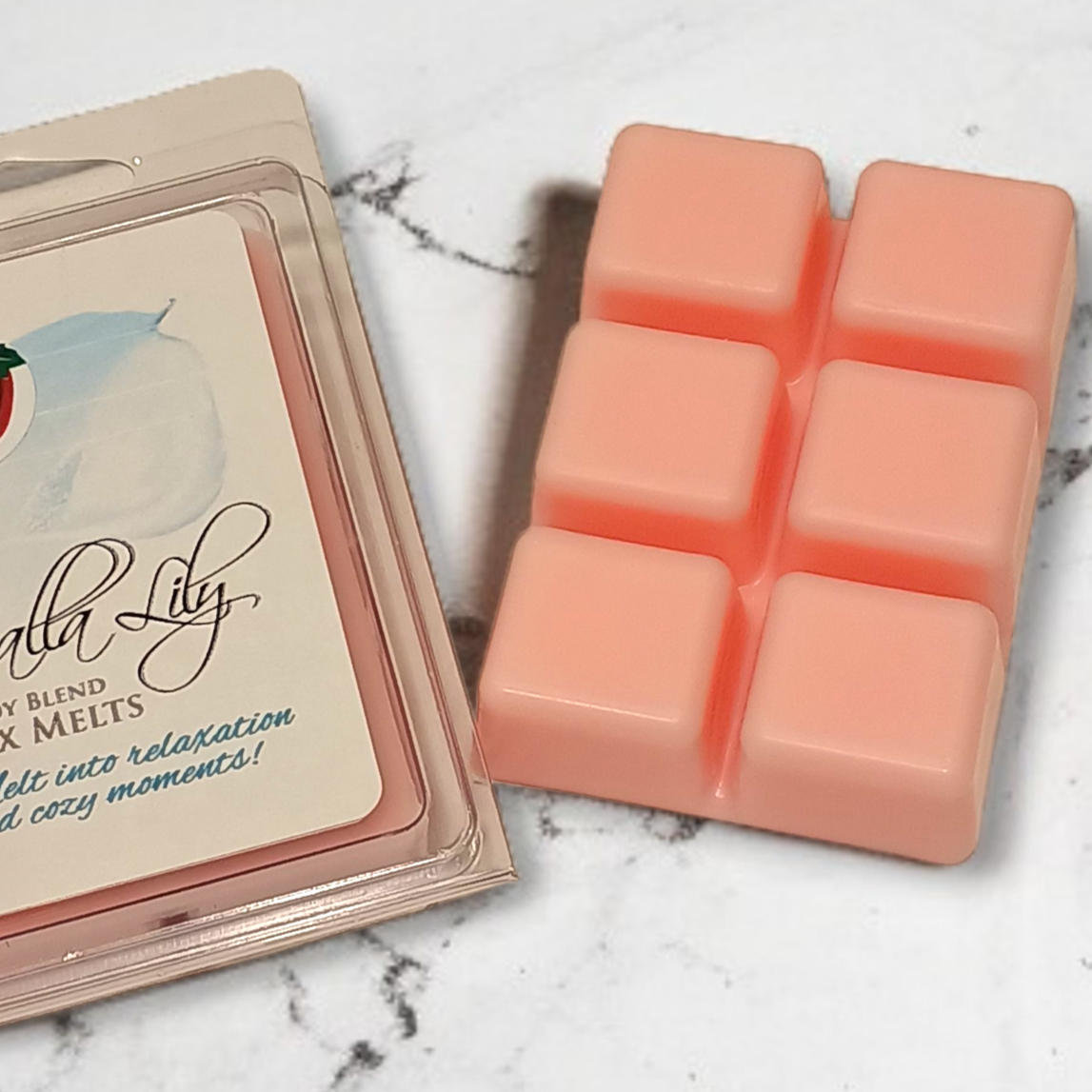 Calla Lily wax melts packaging with pink wax melts on a marble surface