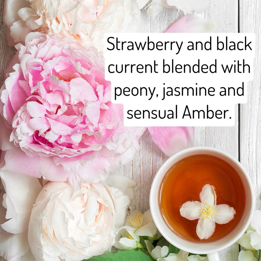 Tea cup with a flower in it surrounded by pink and white flowers on a light wooden surface.