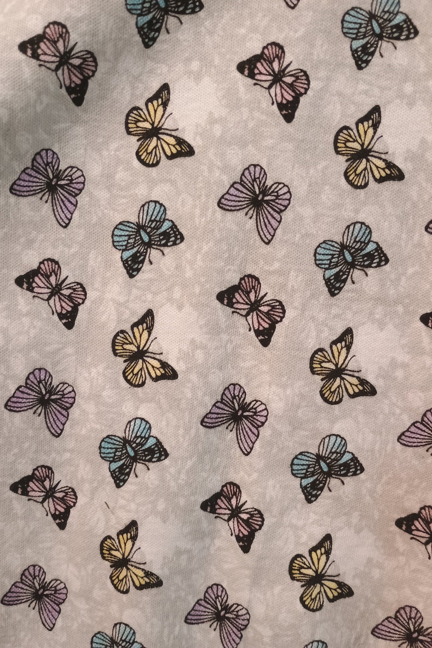 Pattern of colorful butterflies on a textured background