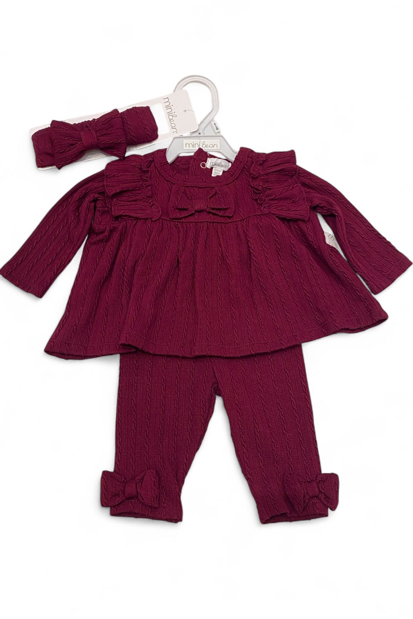 Maroon baby outfit with top, leggings, and headband on a white background