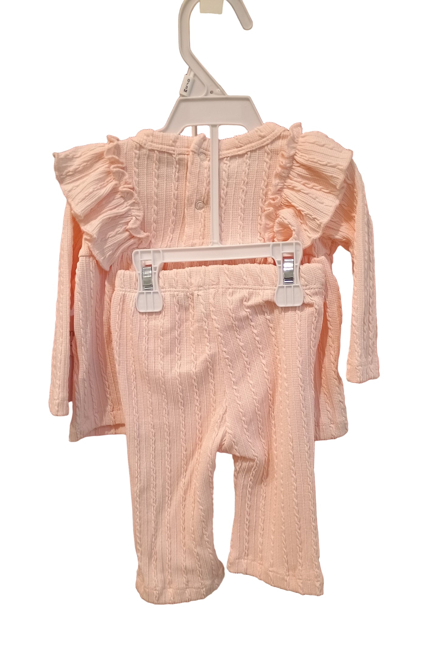 Light pink dress on a hanger against a white background