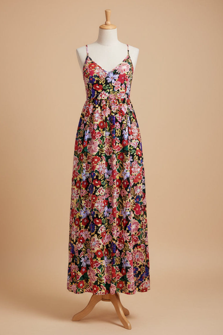 Woman wearing a colorful floral dress on a street.