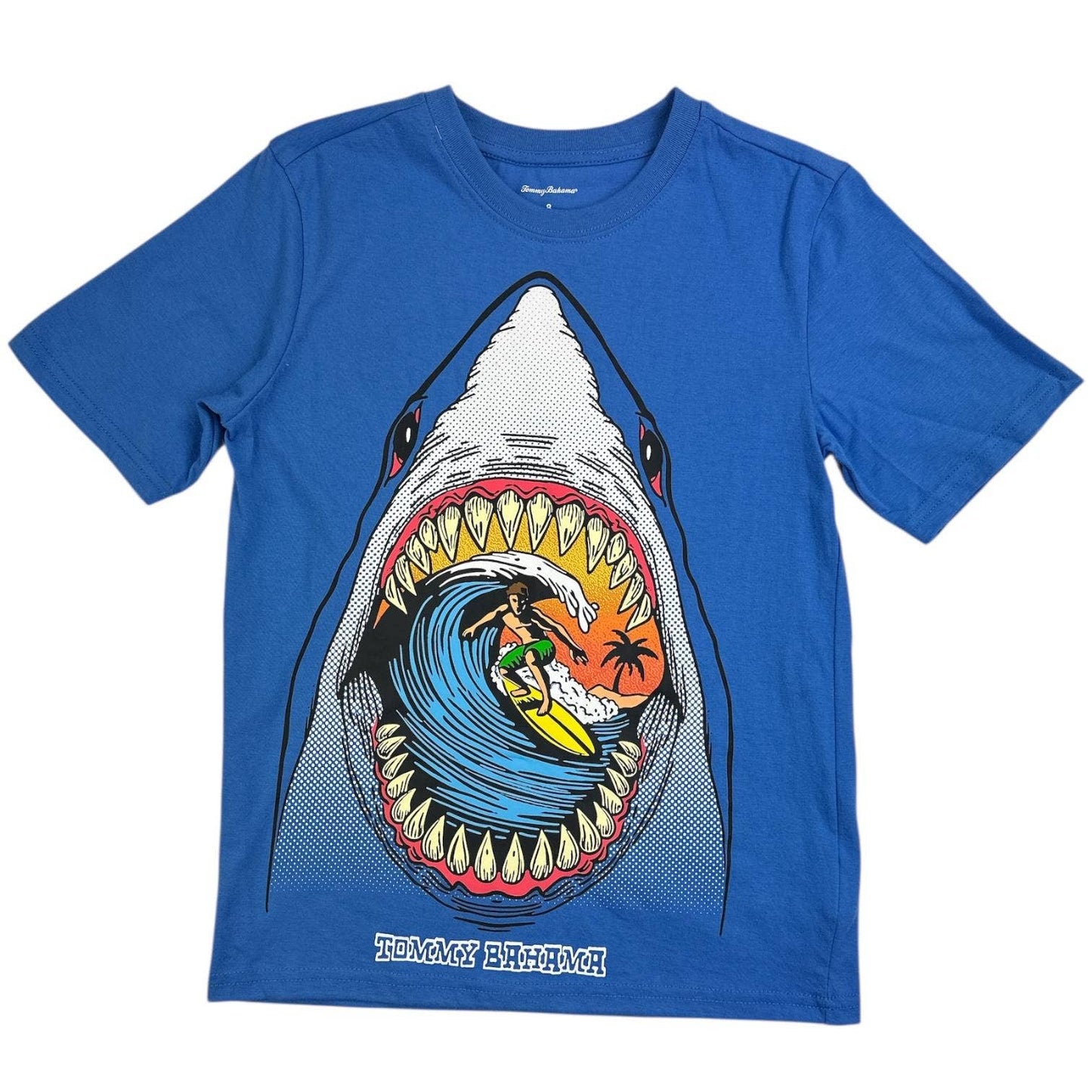 Blue t-shirt with a shark graphic featuring a surfer, on a white background