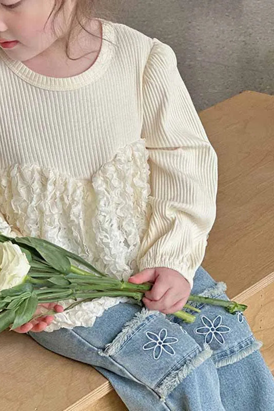 Child holding flowers in a home setting