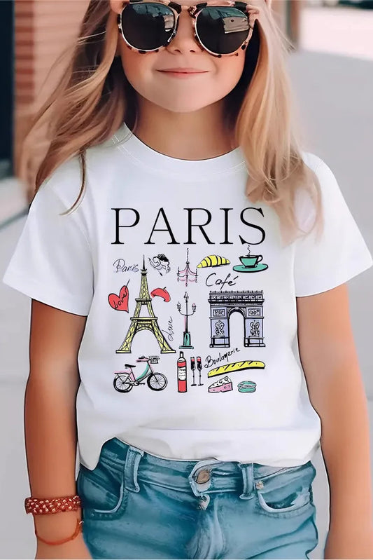 Child wearing a white t-shirt with Paris-themed graphics and text.
