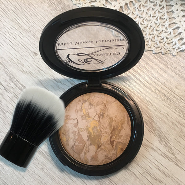 Makeup compact with powder and a brush on a textured surface