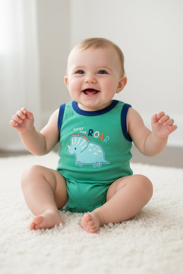 Green baby romper with blue trim and elephant design on a white background