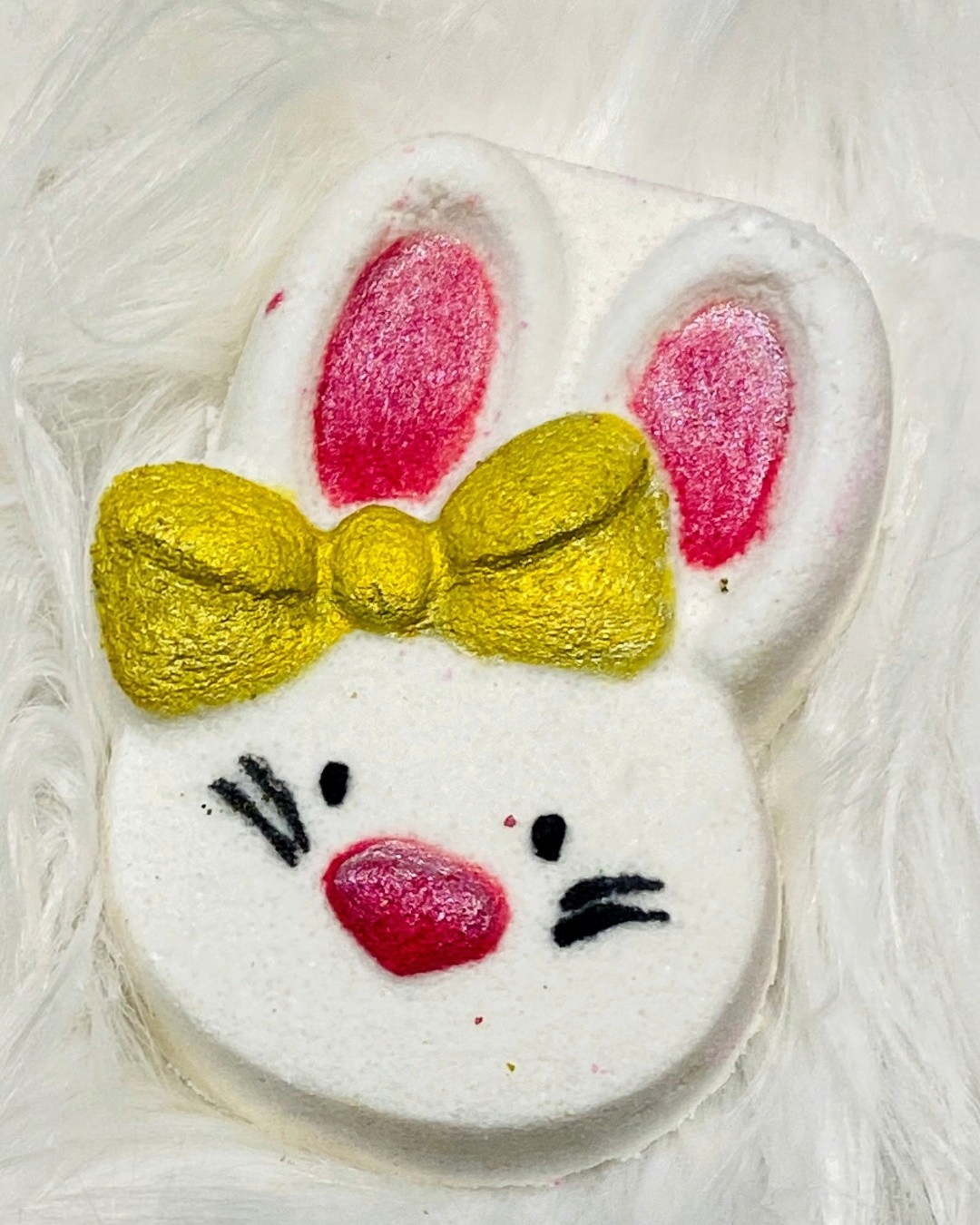 Calla Lily Cosmetics + CL kids white bunny bath bomb with pink ears and a gold glitter bow for kids bath time