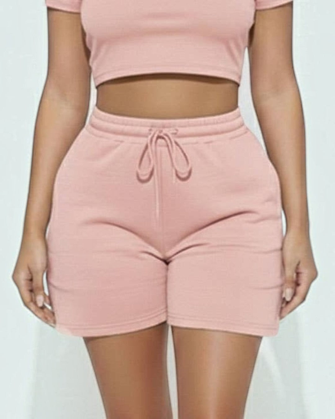 Calla Lily Cosmetics + CL kids pink cotton blend crop tee and drawstring shorts set on a model.