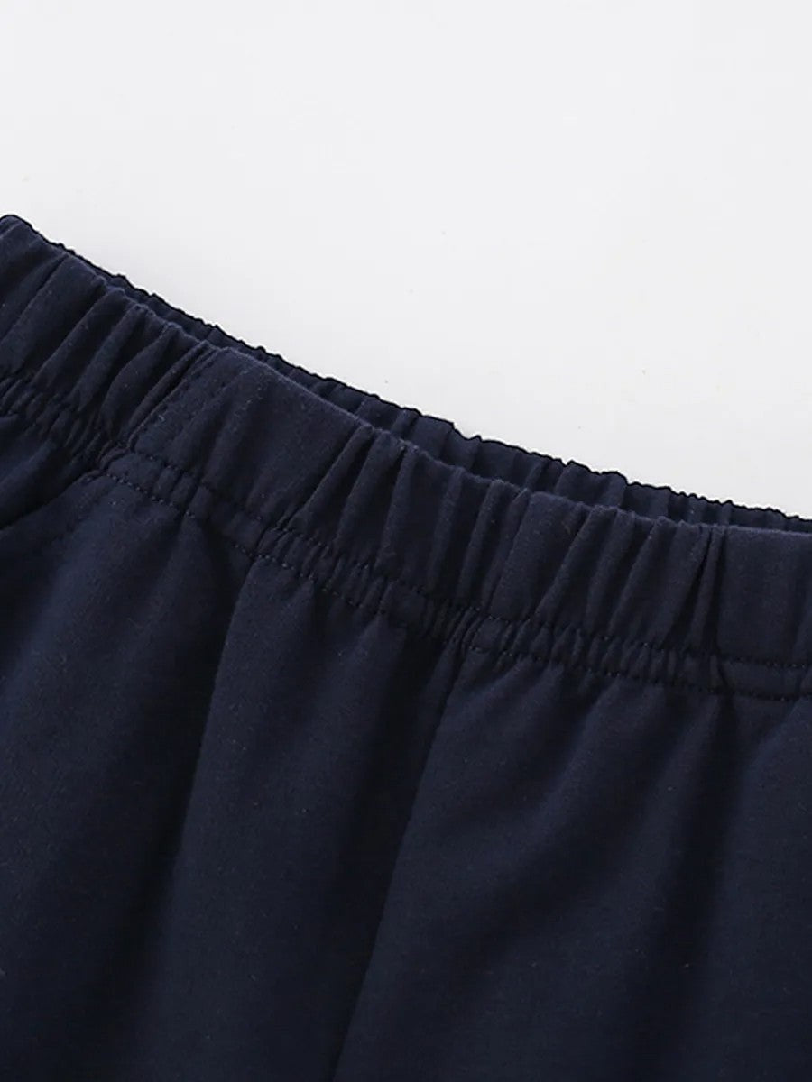 Close-up of navy blue pants with an elastic waistband on a light gray background
