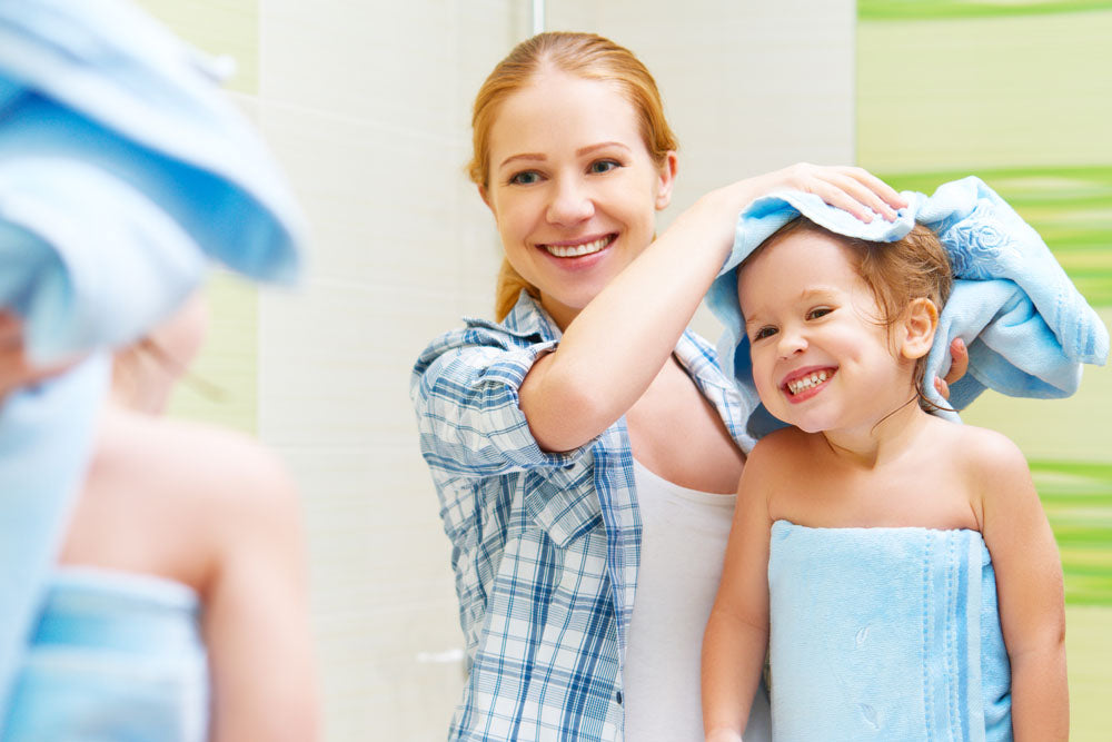 main image of mother helping young daughter at bath time