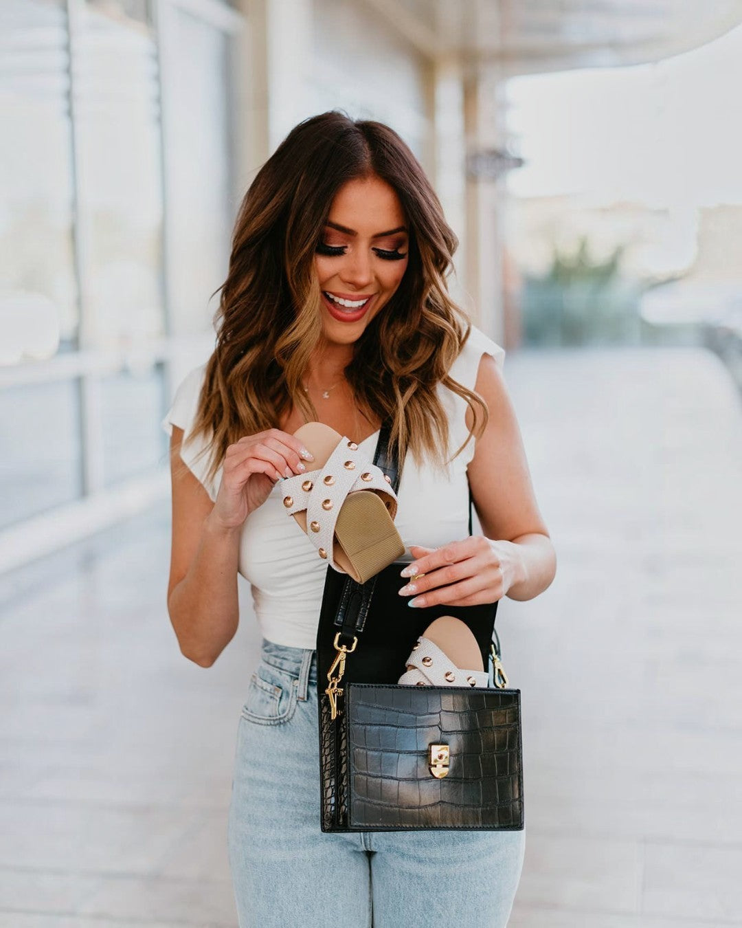 Woman holding a black handbag with a blurred background