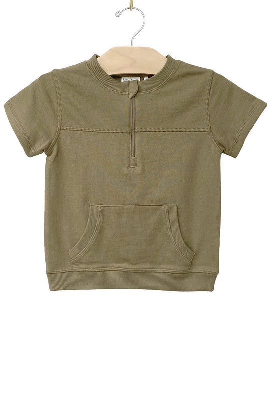 Green short-sleeve pullover with a pocket on a beige hanger against a white background
