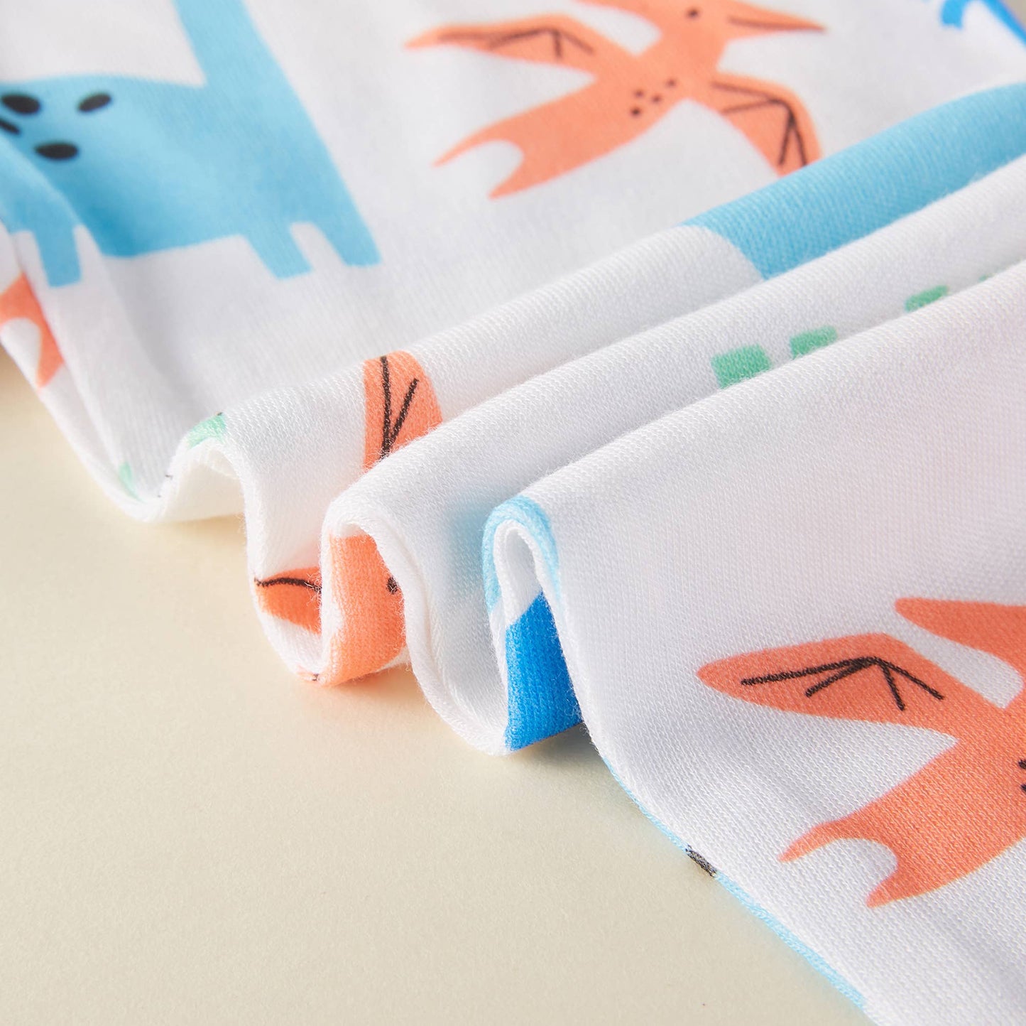 Folded fabric with cartoon fox pattern on a beige background