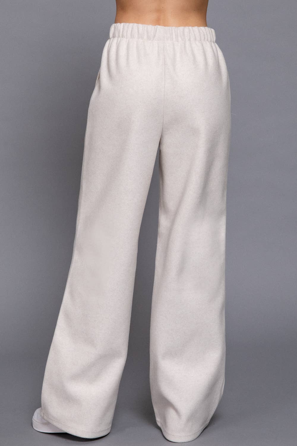 Light gray sweatpants on a gray background