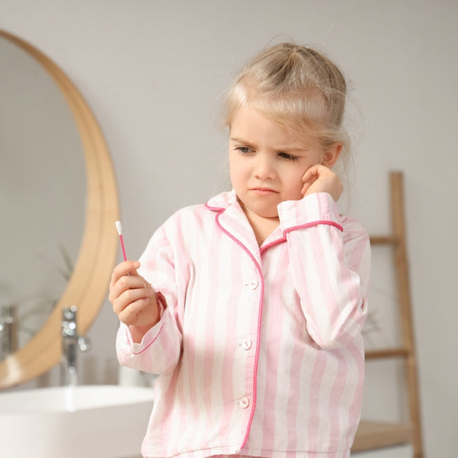 sensory overload kid with from on face in fromnt of bath tub