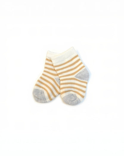 Pair of striped socks with yellow and gray pattern on a white background