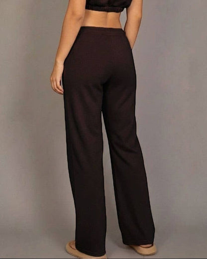 Woman wearing a brown outfit against a gray background