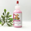 A bottle of our pink bunny tracks bath paints against a white background