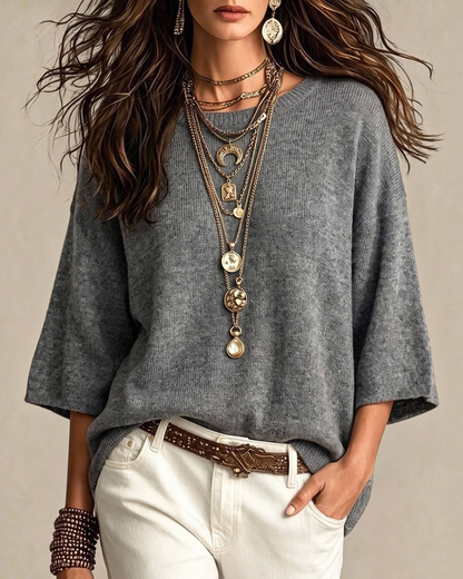 Calla Lily Cosmetics + CL kids grey 3/4 sleeve knit sweater worn with layered gold necklaces and white trousers