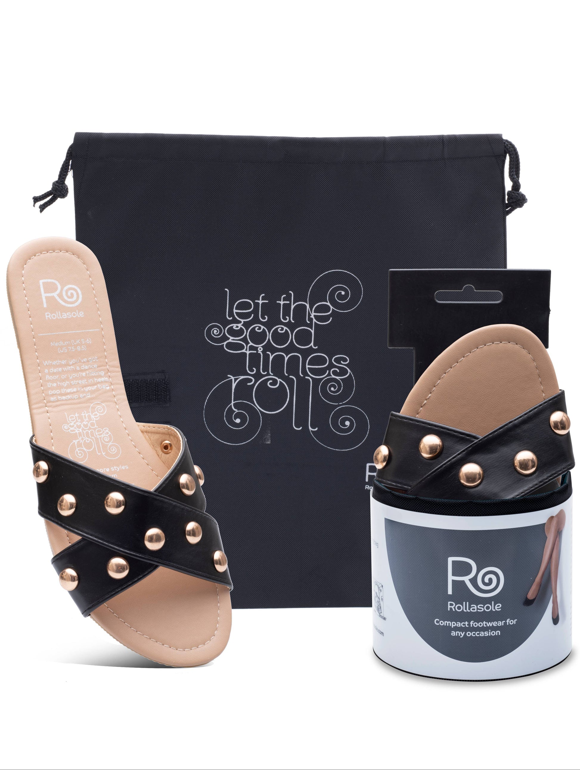 Black sandal with gold studs, packaging, and promotional bag on a white background
