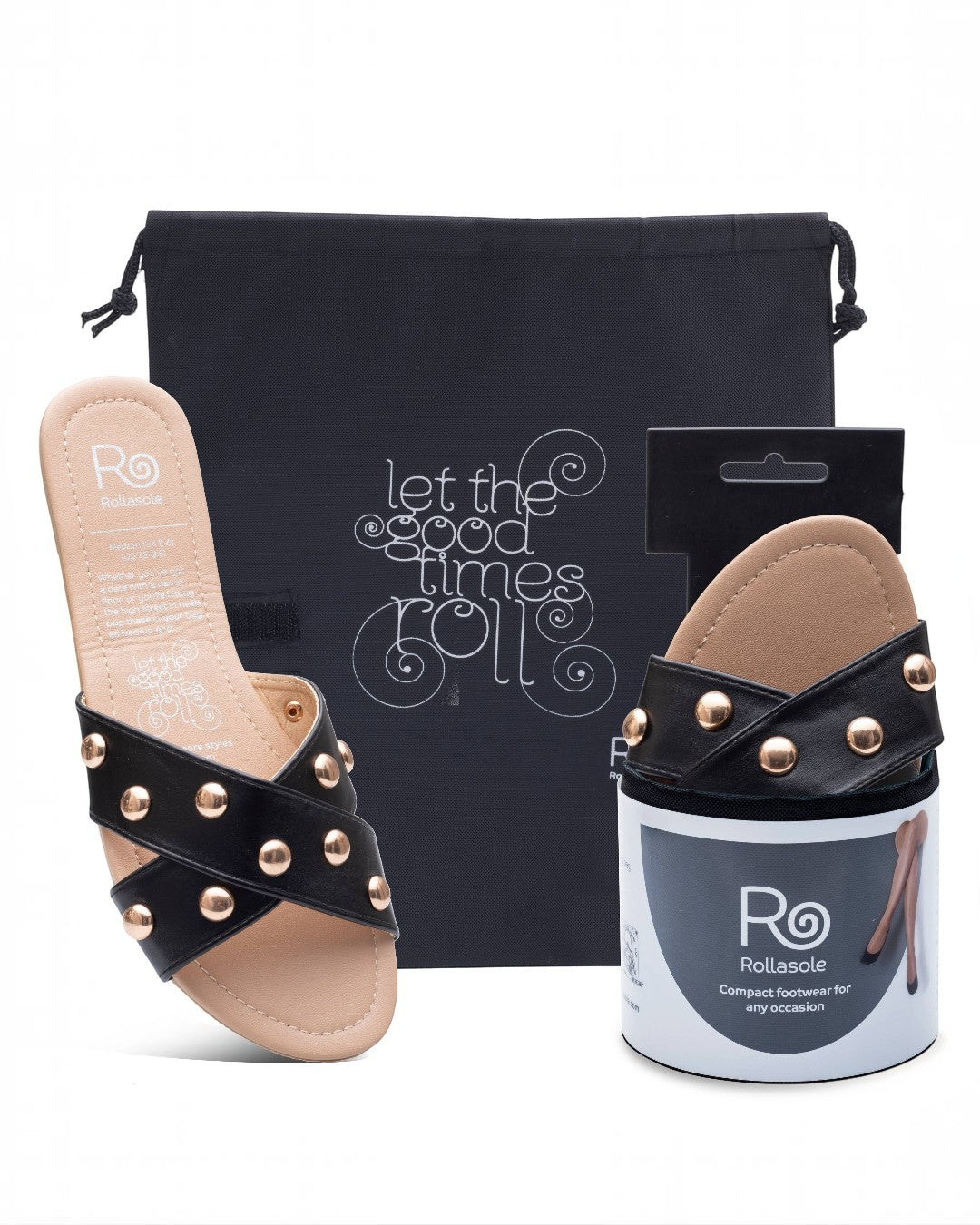 Black sandal with gold studs, packaging, and promotional bag on a white background