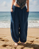 Person wearing blue harem pants by a pool