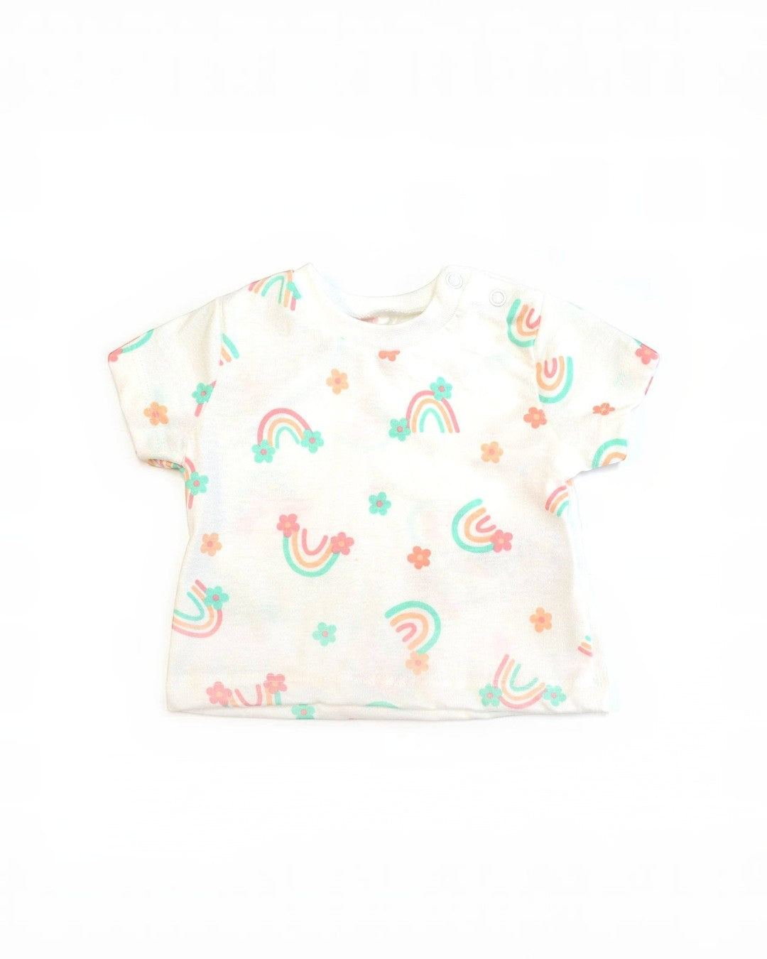 White baby onesie with rainbow and flower patterns on a white background