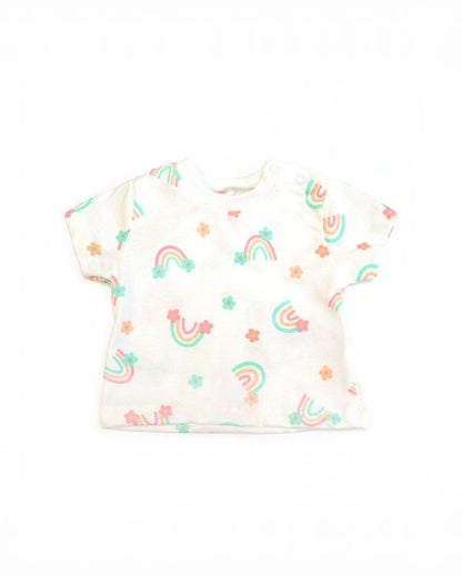 White baby onesie with rainbow and flower patterns on a white background