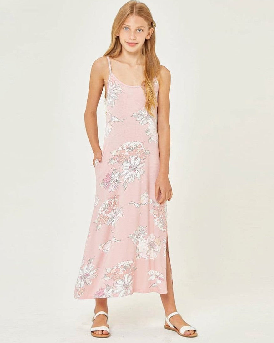 Young girl wearing a pink floral dress on a white background