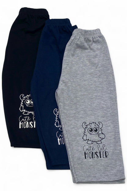 Three pairs of children's sweatpants, one navy and one gray, with a 'Cute Lil Monster' design.