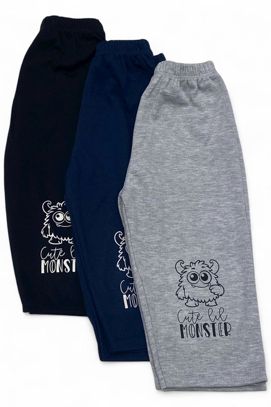 Three pairs of children's sweatpants, one navy and one gray, with a 'Cute Lil Monster' design.