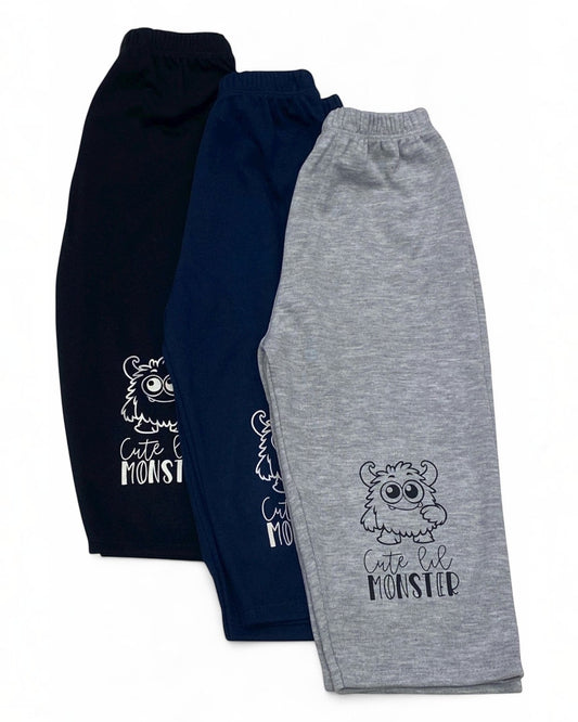 Three pairs of children's sweatpants, one navy and one gray, with a 'Cute Lil Monster' design.