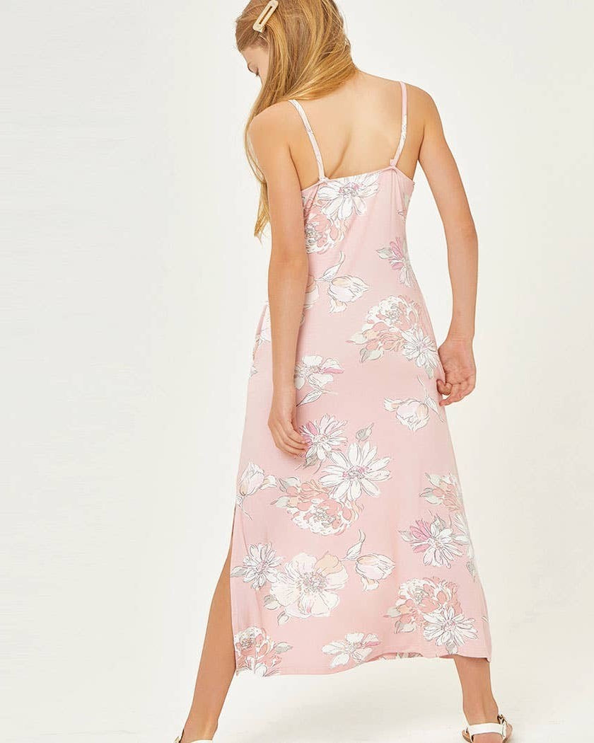 Woman wearing a pink floral dress on a white background
