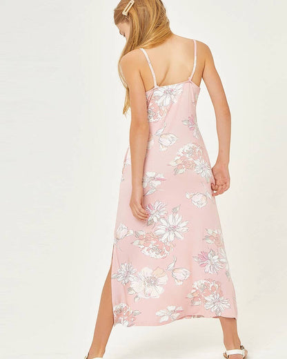 Woman wearing a pink floral dress on a white background