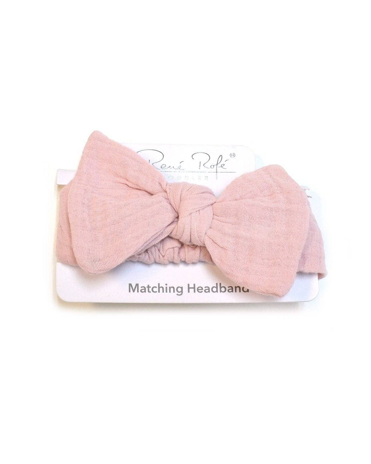 Pink bow headband on a white background