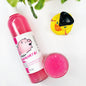 A transparent bottle and cup of our pink piggy snorts body wash against a white background