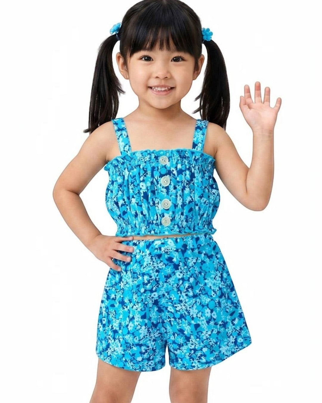 Child wearing a blue floral romper on a white background