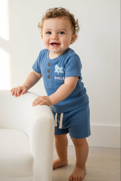 Blue children's outfit with a shirt and shorts on a white background