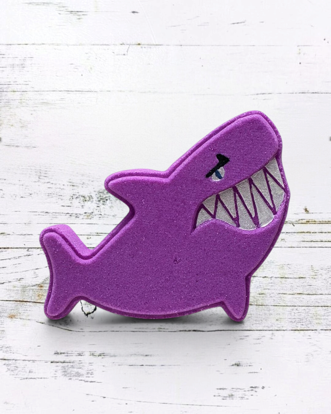 Calla Lily Cosmetics + CL kids purple shark-shaped bath bomb with a grape soda scent and nourishing cocoa butter